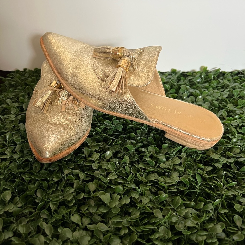Gold Stuart Weitzman slip on pointed mules, size 8.
